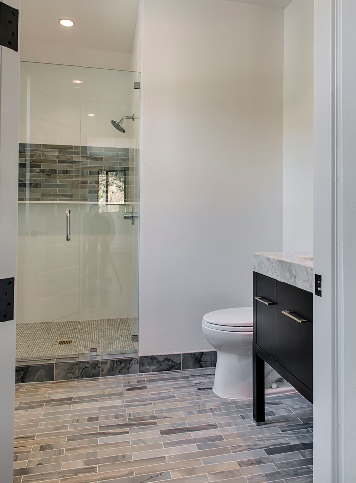 Example of a mid-sized minimalist 3/4 stone tile and brown tile marble floor and multicolored floor corner shower design in Los Angeles with white walls, flat-panel cabinets, black cabinets, quartzite countertops and a hinged shower door