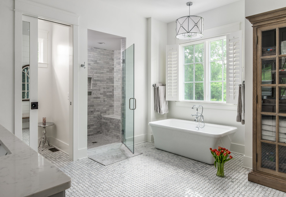 Inspiration for a transitional master gray tile and porcelain tile porcelain tile bathroom remodel in Nashville with shaker cabinets, gray cabinets, gray walls, an undermount sink, quartz countertops, a hinged shower door and white countertops