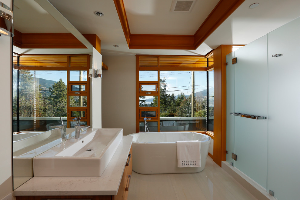 Large trendy master vinyl floor and beige floor bathroom photo in Vancouver with flat-panel cabinets, light wood cabinets, a two-piece toilet, white walls, a vessel sink, marble countertops and a hinged shower door