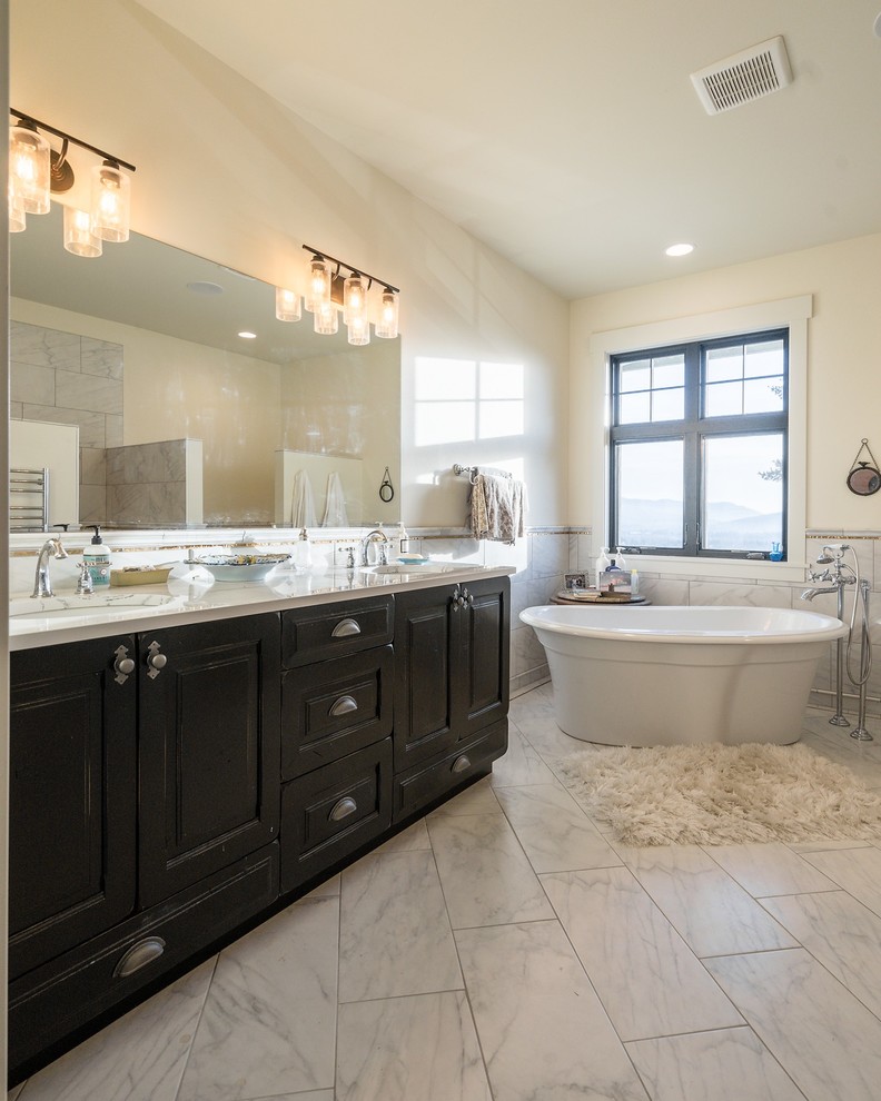 Example of a mid-sized transitional master white tile and marble tile marble floor and white floor bathroom design in Seattle with raised-panel cabinets, dark wood cabinets, beige walls, an undermount sink, quartz countertops and white countertops