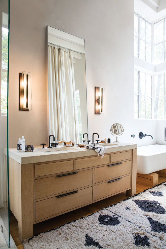 Exempel på ett stort nordiskt vit vitt en-suite badrum, med möbel-liknande, skåp i ljust trä, ett fristående badkar, vita väggar, mellanmörkt trägolv, ett undermonterad handfat och brunt golv