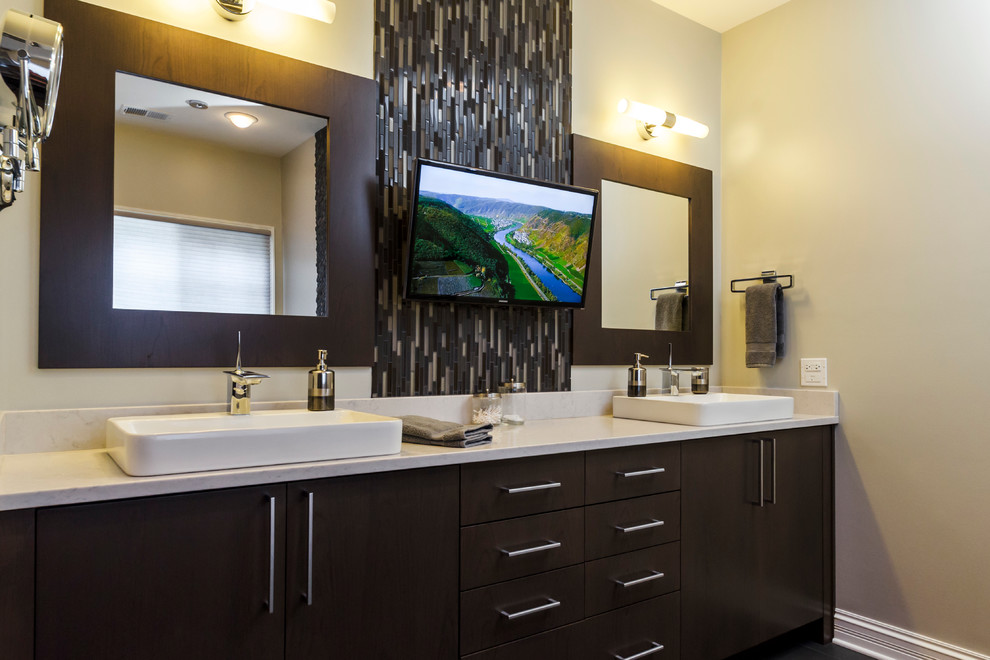 Inspiration for a large contemporary master black tile and porcelain tile porcelain tile bathroom remodel in Chicago with a vessel sink, flat-panel cabinets, dark wood cabinets, quartz countertops, a two-piece toilet and beige walls