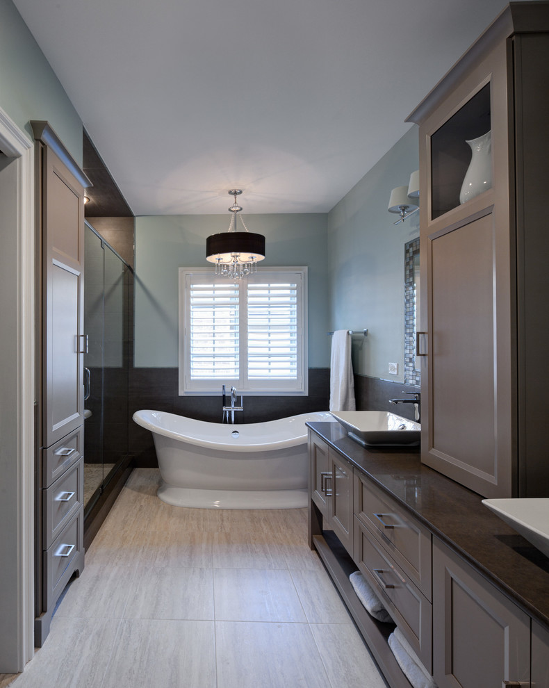 Example of a transitional master beige tile and porcelain tile porcelain tile bathroom design in Chicago with a vessel sink, recessed-panel cabinets, brown cabinets, a one-piece toilet and blue walls