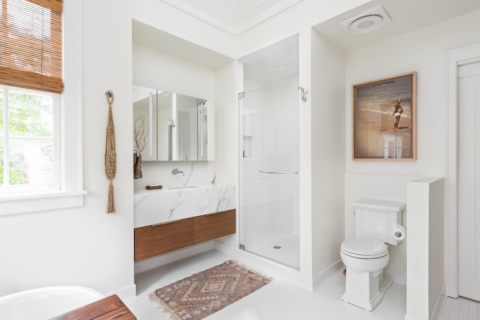 This is an example of a large country ensuite bathroom in Chicago with open cabinets, light wood cabinets, a freestanding bath, an alcove shower, a one-piece toilet, white tiles, metro tiles, a submerged sink, engineered stone worktops, a hinged door and white worktops.