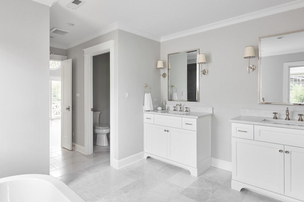 Design ideas for a medium sized traditional shower room bathroom in Chicago with recessed-panel cabinets, white cabinets, a freestanding bath, an alcove shower, grey tiles, white tiles, marble tiles, grey walls, marble flooring, a submerged sink, marble worktops, grey floors and a hinged door.