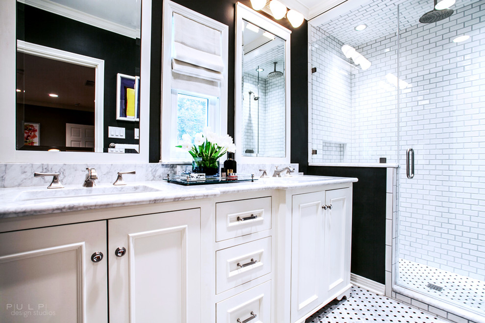 Trendy white tile and subway tile mosaic tile floor alcove shower photo in Seattle with an undermount sink, raised-panel cabinets, white cabinets, marble countertops, a one-piece toilet and black walls