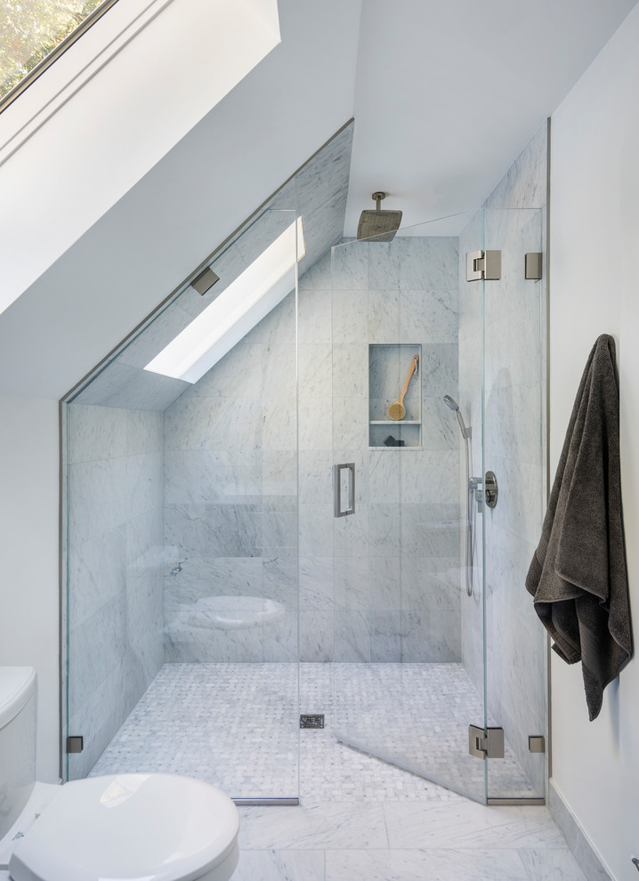 Walk-in shower - mid-sized modern master gray tile, white tile and marble tile marble floor and multicolored floor walk-in shower idea in Boston with flat-panel cabinets, dark wood cabinets, a two-piece toilet, white walls, an integrated sink, quartz countertops, a hinged shower door and white countertops