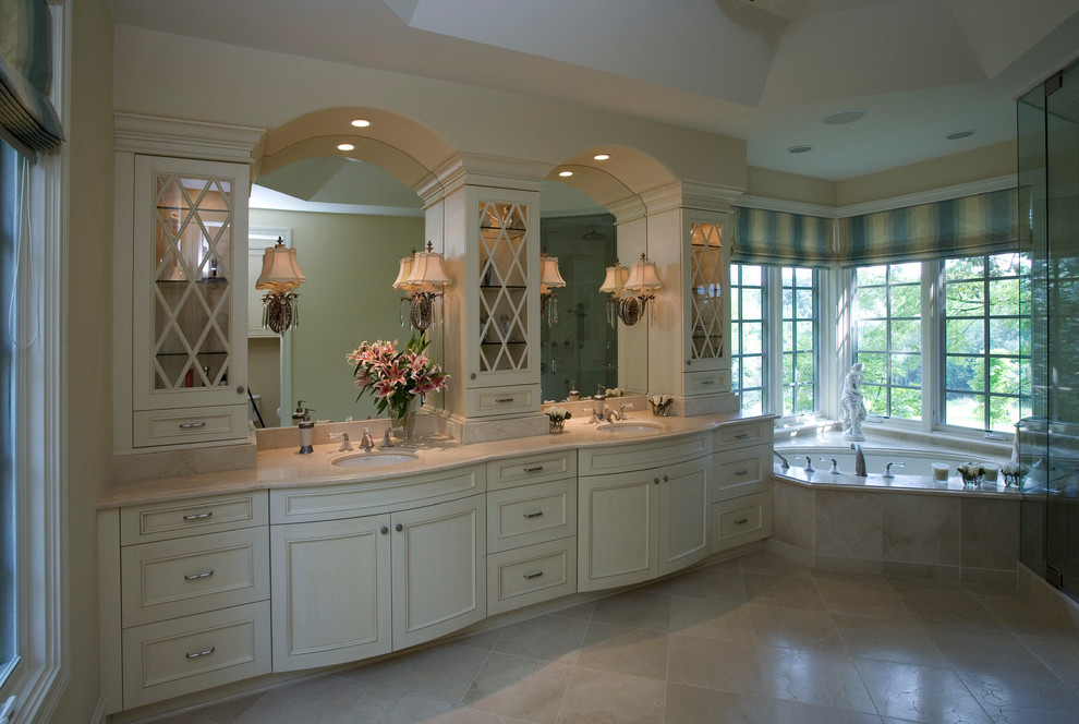 His and Her Vanities with archtopped mirrors and glassfronted towers Traditional Bathroom