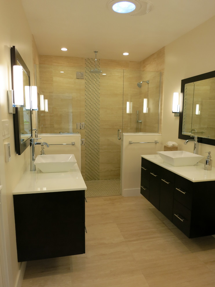 Medium sized contemporary ensuite bathroom in Los Angeles with flat-panel cabinets, dark wood cabinets, a built-in shower, beige tiles, travertine tiles, beige walls, travertine flooring, a vessel sink, engineered stone worktops, beige floors and a hinged door.