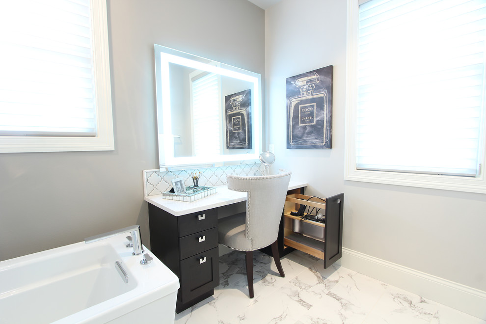 Inspiration for a large transitional master white tile and porcelain tile marble floor and white floor bathroom remodel in Other with recessed-panel cabinets, brown cabinets, a two-piece toilet, gray walls, an undermount sink, quartz countertops, a hinged shower door and white countertops