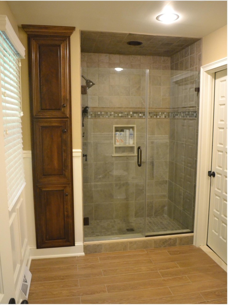 Alcove shower - large traditional master light wood floor alcove shower idea in Philadelphia with dark wood cabinets, beige walls, raised-panel cabinets, a two-piece toilet, an undermount sink and marble countertops