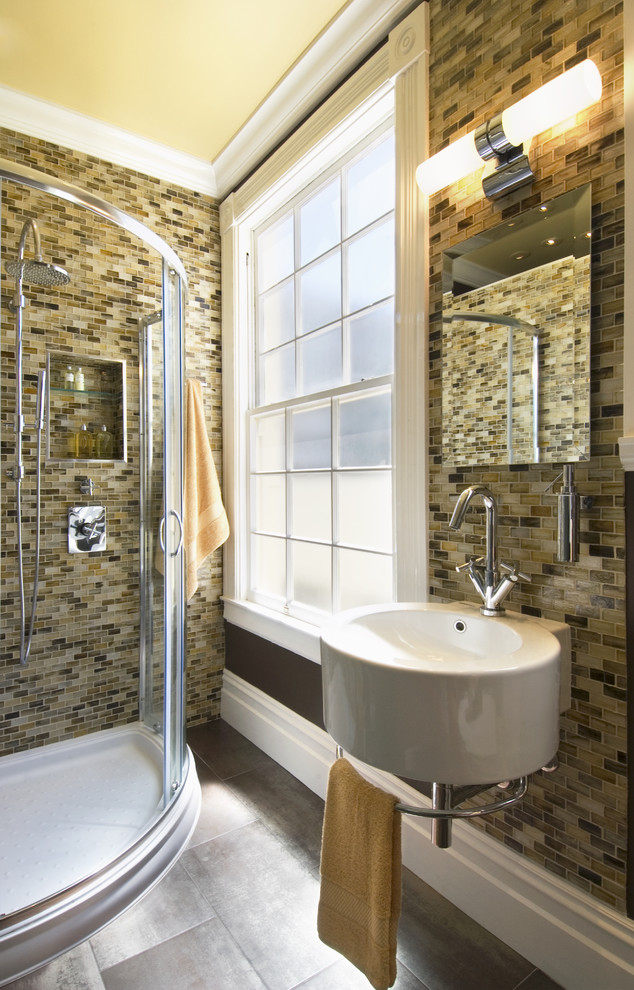 На фото: ванная комната в современном стиле с стеклянной плиткой, подвесной раковиной и коричневой плиткой с