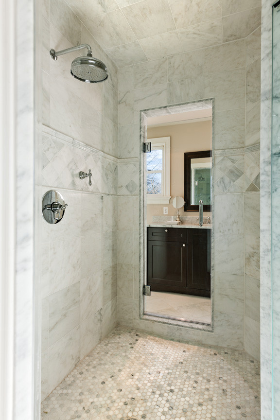 Large traditional ensuite bathroom in Philadelphia with a claw-foot bath, a two-piece toilet, stone slabs, beige walls, a submerged sink, shaker cabinets, black cabinets, an alcove shower, grey tiles, white tiles, marble flooring and marble worktops.