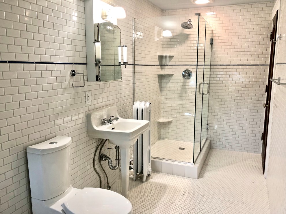 Small classic shower room bathroom in Austin with freestanding cabinets, white cabinets, a corner shower, a two-piece toilet, white tiles, ceramic tiles, white walls, ceramic flooring, a pedestal sink, white floors and a hinged door.