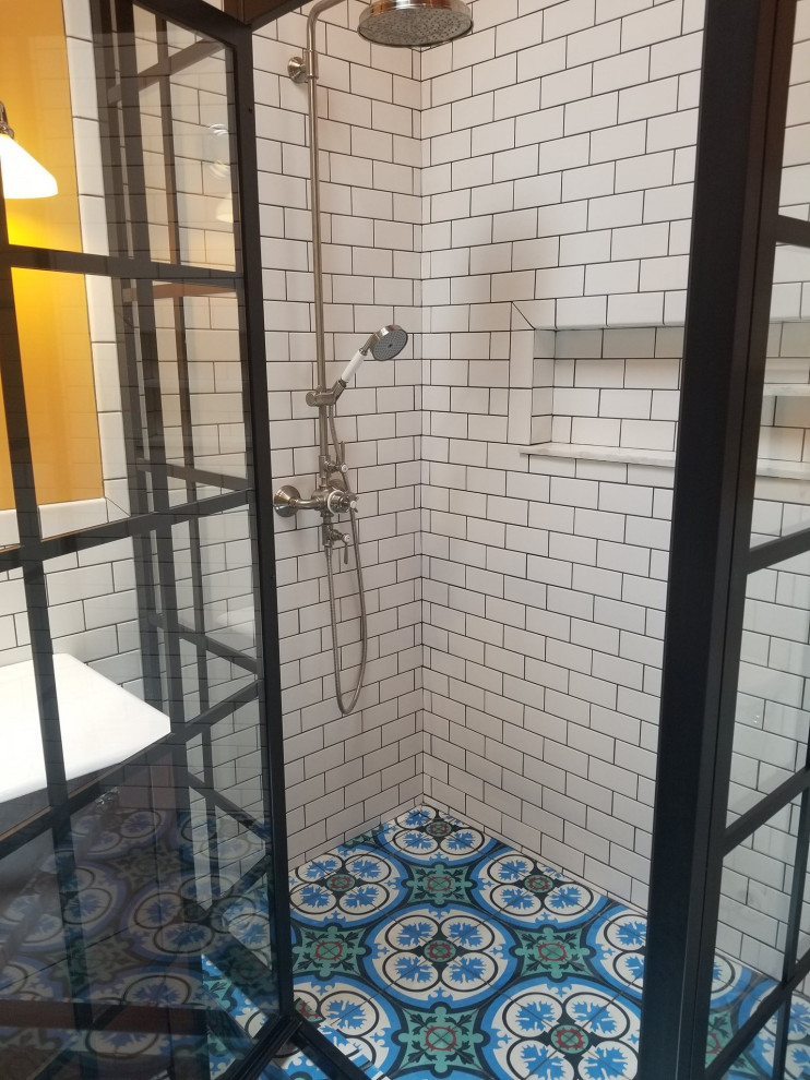 Exemple d'une grande salle de bain principale chic avec des portes de placard marrons, une baignoire sur pieds, une douche d'angle, un carrelage bleu, des carreaux de béton, un mur orange, carreaux de ciment au sol, un sol bleu, une cabine de douche à porte battante, un plan de toilette blanc, meuble simple vasque et meuble-lavabo encastré.