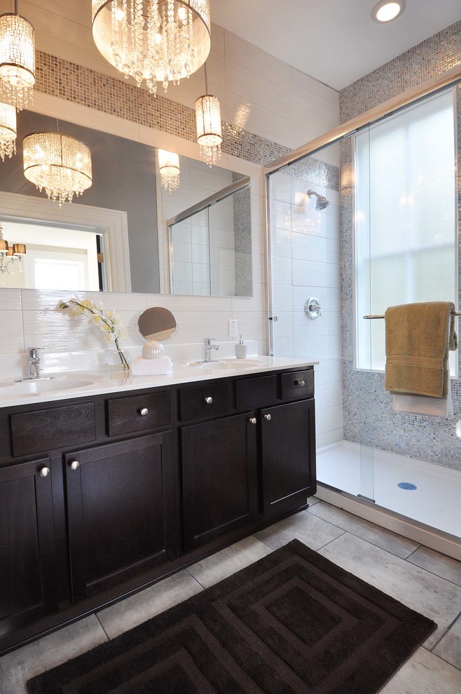 Example of a mid-sized classic master ceramic tile alcove shower design in St Louis with shaker cabinets, dark wood cabinets and an integrated sink