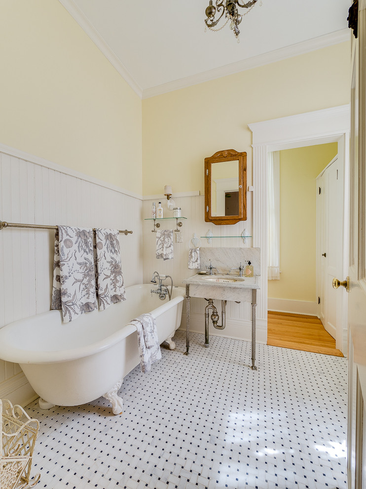Inspiration for a traditional bathroom in New York with a claw-foot bath, porcelain flooring, a console sink and white floors.