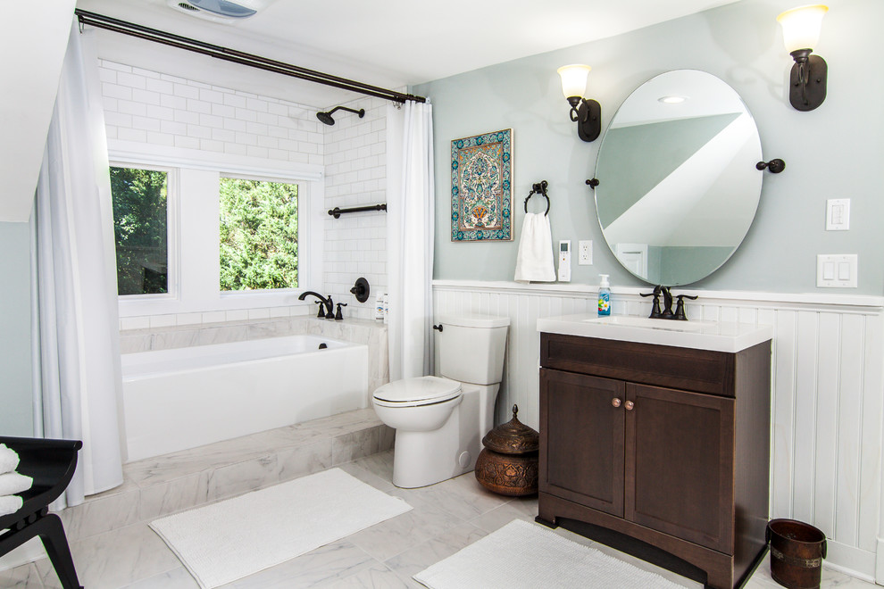 Example of a large classic master white tile and ceramic tile ceramic tile and gray floor bathroom design in Baltimore with recessed-panel cabinets, dark wood cabinets, gray walls, an integrated sink, solid surface countertops and a two-piece toilet