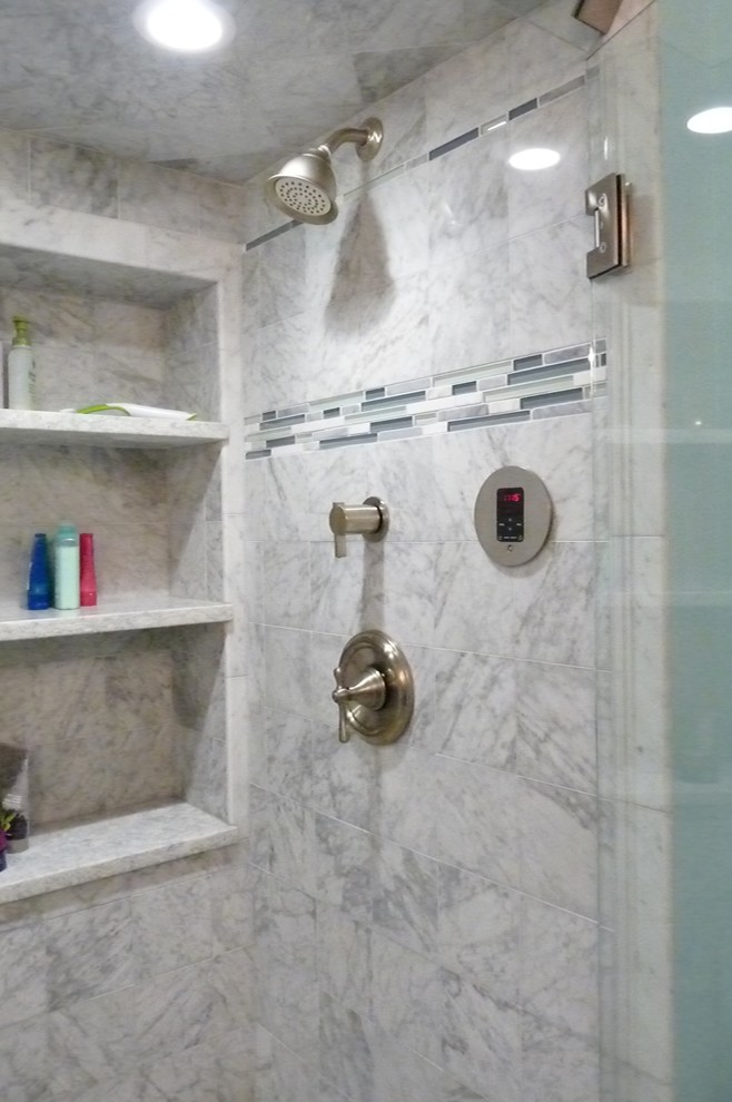 Inspiration for a small traditional shower room bathroom in New York with a one-piece toilet, grey tiles, stone tiles, blue walls, a submerged sink, recessed-panel cabinets, white cabinets, an alcove shower, marble flooring and marble worktops.