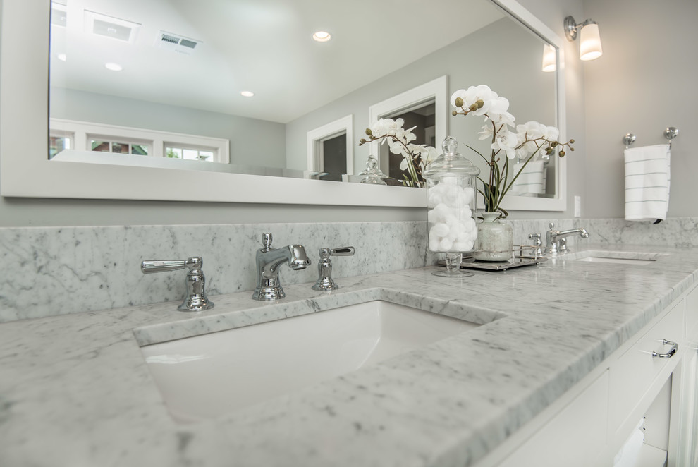 Example of a huge transitional master gray tile and marble tile marble floor and gray floor bathroom design in Portland with recessed-panel cabinets, white cabinets, a one-piece toilet, gray walls, an undermount sink, marble countertops and a hinged shower door