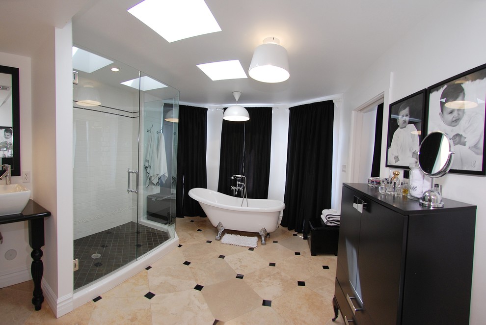Design ideas for a medium sized traditional ensuite bathroom in Phoenix with a pedestal sink, flat-panel cabinets, black cabinets, granite worktops, a claw-foot bath, black tiles, stone tiles, white walls and travertine flooring.
