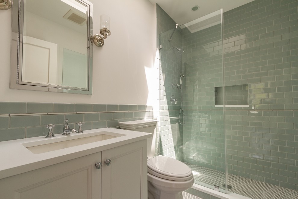 Example of a classic kids' green tile and porcelain tile porcelain tile and white floor alcove shower design in New York with recessed-panel cabinets, white cabinets, a two-piece toilet, white walls, an undermount sink and quartz countertops