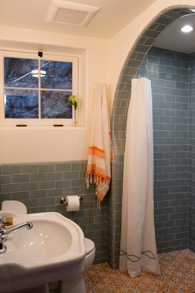 Photo of a mediterranean bathroom in Los Angeles with an alcove shower and blue tiles.