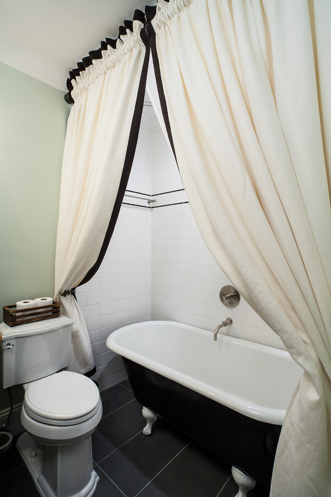 This is an example of a classic cream and black bathroom in Atlanta with a freestanding bath.