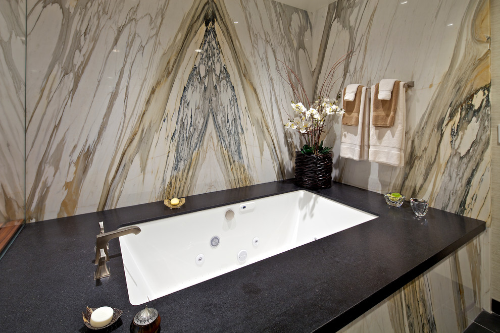 Large classic ensuite bathroom in San Diego with dark wood cabinets, a corner bath and a submerged sink.
