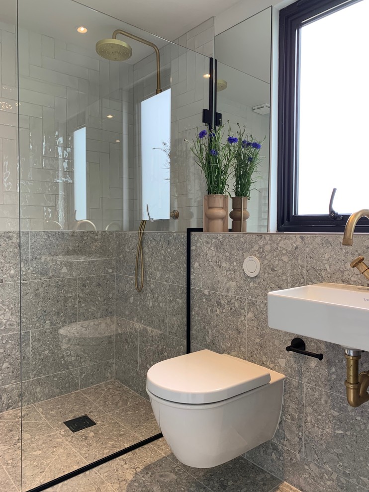 Foto på ett litet funkis en-suite badrum, med en öppen dusch, en vägghängd toalettstol, flerfärgad kakel, porslinskakel, beige väggar, klinkergolv i porslin, ett väggmonterat handfat, beiget golv och med dusch som är öppen