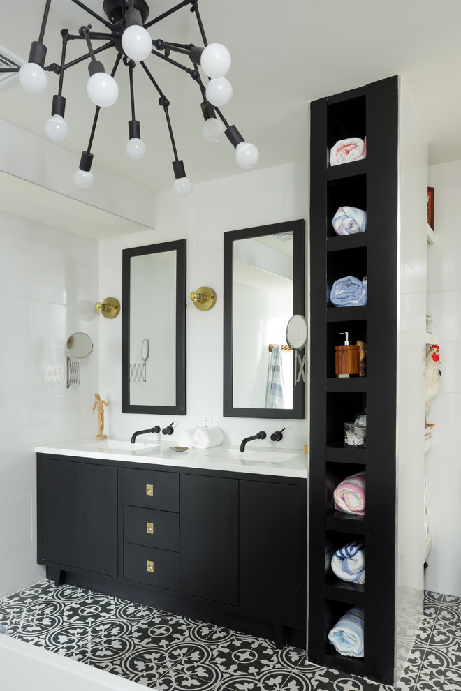 This is an example of a mid-sized contemporary 3/4 bathroom in Philadelphia with shaker cabinets, black cabinets, an alcove tub, a two-piece toilet, white tile, ceramic tile, white walls, cement tiles, an undermount sink and engineered quartz benchtops.