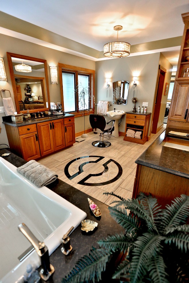 This is an example of a large classic ensuite bathroom in Chicago with a submerged sink, raised-panel cabinets, medium wood cabinets, granite worktops, a built-in bath, beige tiles, stone tiles, beige walls and porcelain flooring.