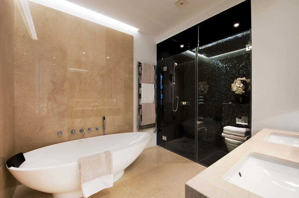 Example of a mid-sized trendy master black tile and mosaic tile marble floor bathroom design in London with flat-panel cabinets, beige cabinets, a wall-mount toilet, beige walls, an undermount sink and marble countertops