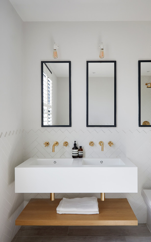 Design ideas for a scandi bathroom in London with open cabinets, white tiles, ceramic tiles, white walls, an integrated sink and white worktops.