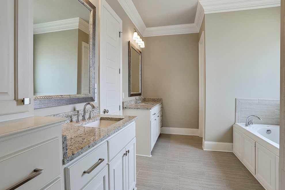 Elegant master beige tile and ceramic tile ceramic tile and beige floor bathroom photo in New Orleans with raised-panel cabinets, white cabinets, a two-piece toilet, beige walls, an undermount sink, granite countertops and a hinged shower door
