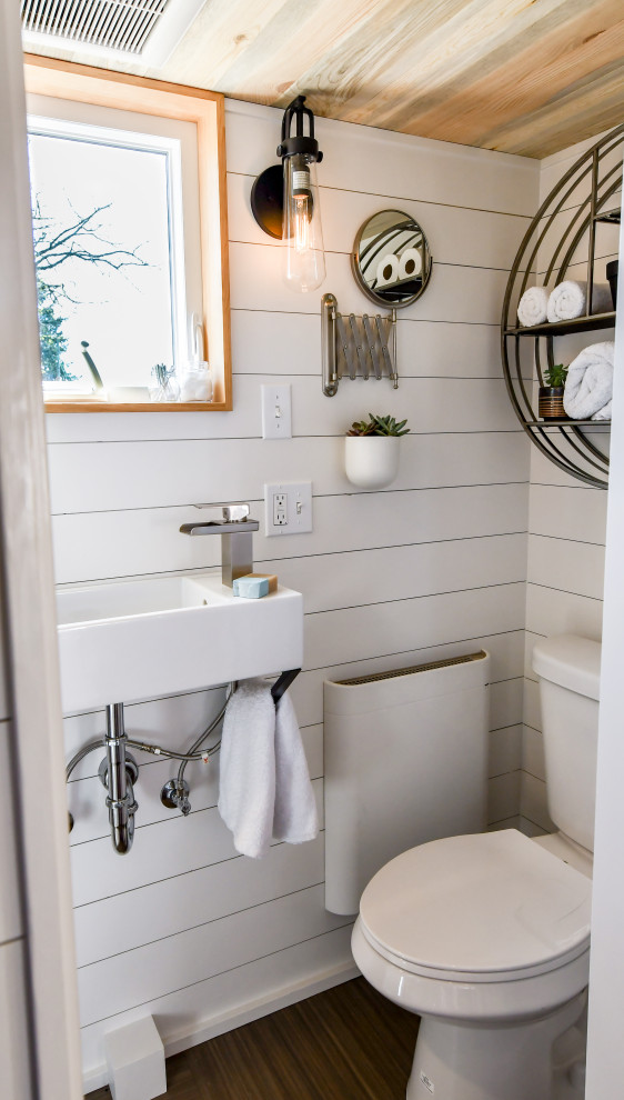 Small country shower room bathroom in Other with a walk-in shower, a one-piece toilet, white walls, lino flooring, a wall-mounted sink, brown floors, a shower curtain, a single sink, a floating vanity unit, a wood ceiling and tongue and groove walls.