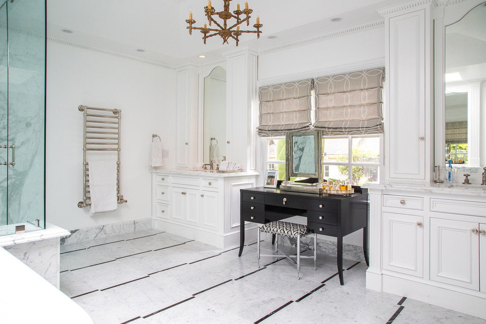 Large elegant white tile marble floor bathroom photo in Los Angeles with an undermount sink, recessed-panel cabinets, white cabinets, white walls and marble countertops