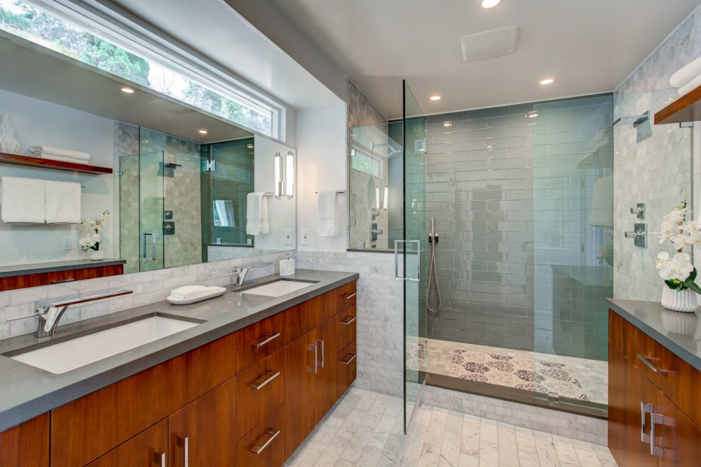 Alcove shower - large modern master multicolored tile and stone tile marble floor alcove shower idea with flat-panel cabinets, dark wood cabinets, gray walls, an undermount sink and quartz countertops