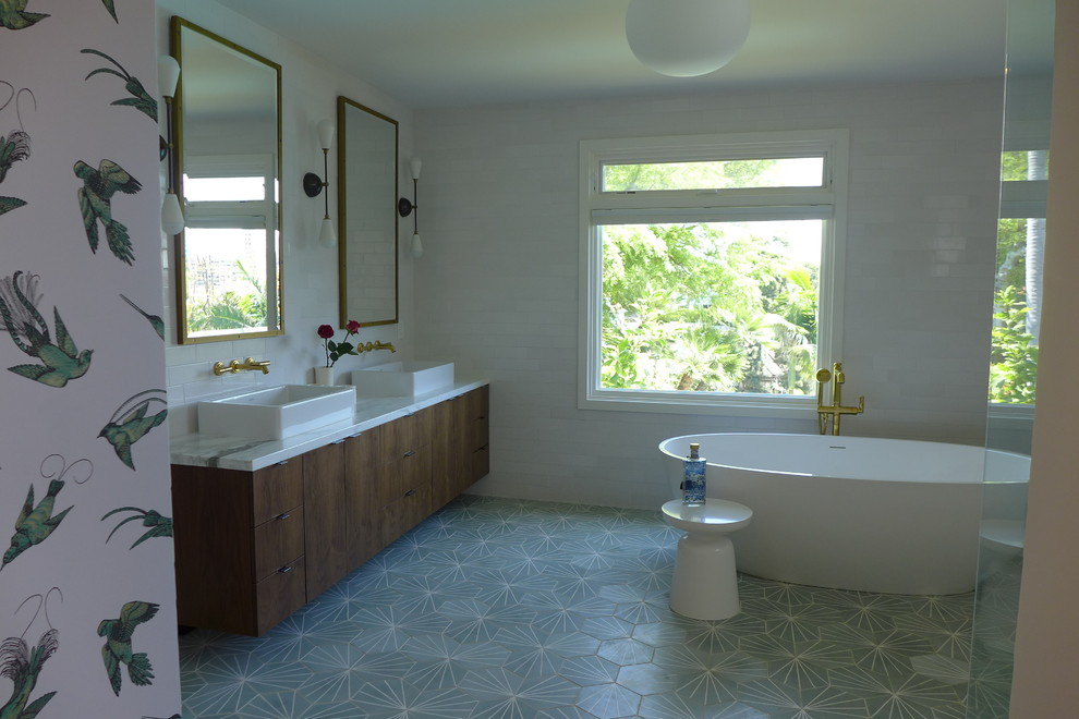 Example of a large trendy master white tile and ceramic tile cement tile floor and green floor bathroom design in Los Angeles with flat-panel cabinets, dark wood cabinets, a one-piece toilet, white walls, a vessel sink and marble countertops