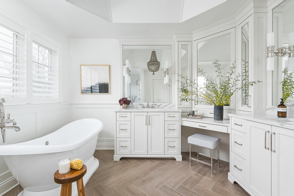 Large transitional master brown floor freestanding bathtub photo in Chicago with white cabinets, white walls, white countertops, shaker cabinets and an undermount sink