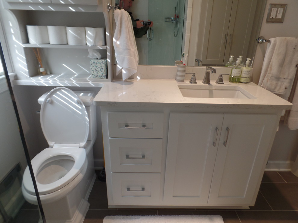 Small classic bathroom in Other with shaker cabinets, white cabinets, an alcove bath, an alcove shower, a two-piece toilet, grey tiles, ceramic tiles, grey walls, porcelain flooring, a submerged sink and engineered stone worktops.