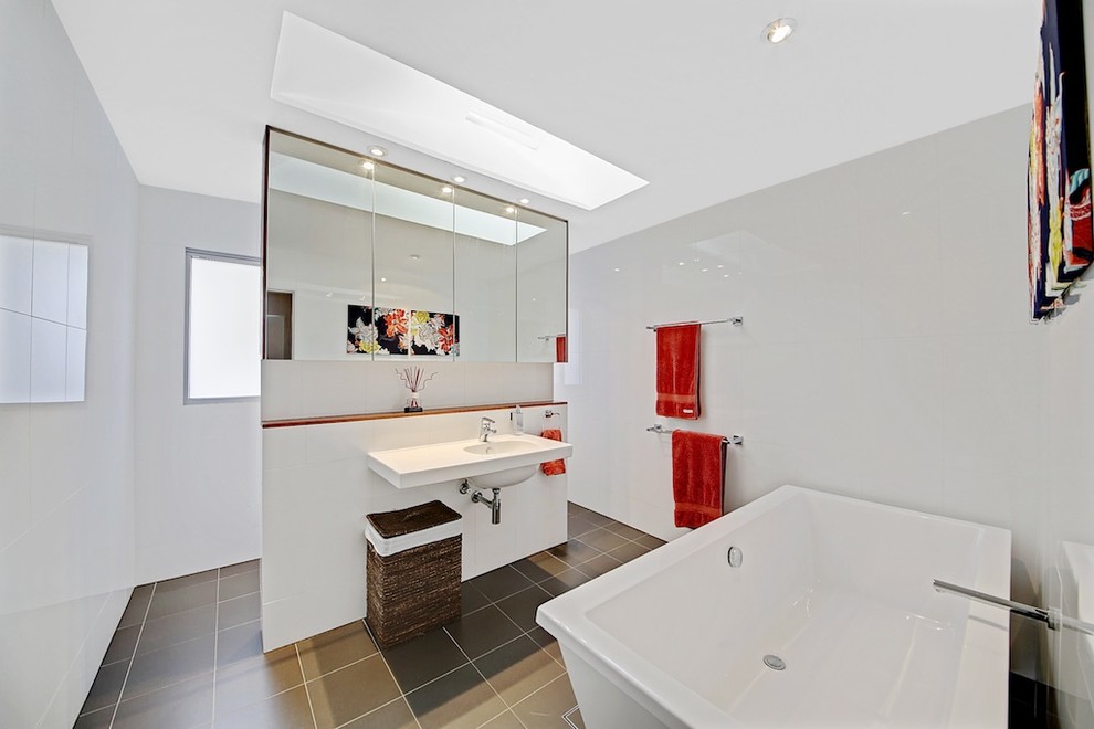 Contemporary ensuite bathroom in Sydney with a wall-mounted sink, a freestanding bath, a walk-in shower, brown tiles and white walls.