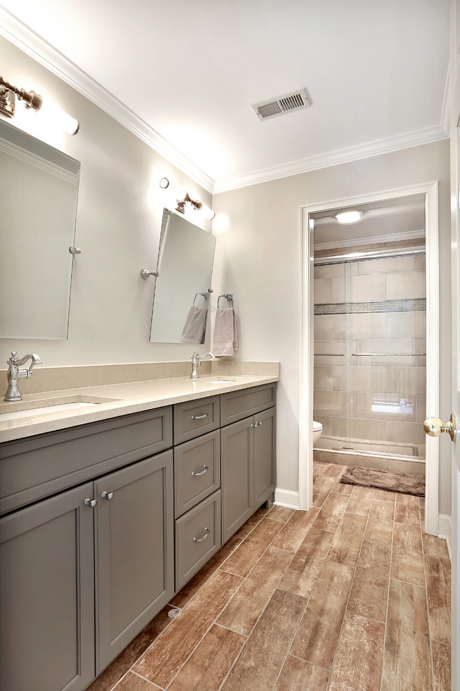 Design ideas for a large traditional shower room bathroom in Atlanta with recessed-panel cabinets, grey cabinets, an alcove shower, beige tiles, porcelain tiles, beige walls, porcelain flooring, a submerged sink, quartz worktops, beige floors and a sliding door.