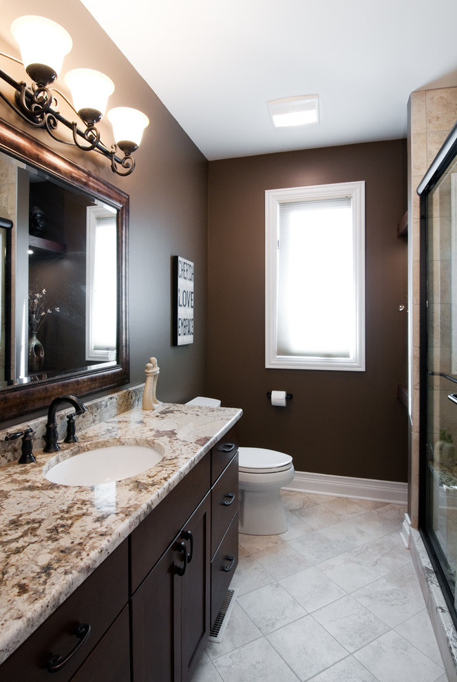 Inspiration for a medium sized traditional shower room bathroom in Chicago with shaker cabinets, brown cabinets, beige tiles, travertine tiles, brown walls, travertine flooring, a submerged sink, granite worktops, beige floors and a sliding door.