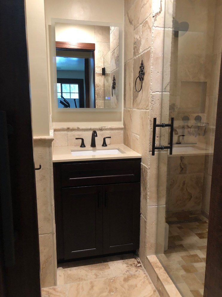 Medium sized mediterranean ensuite bathroom in Other with shaker cabinets, beige cabinets, a double shower, a two-piece toilet, beige tiles, travertine tiles, a submerged sink and a hinged door.