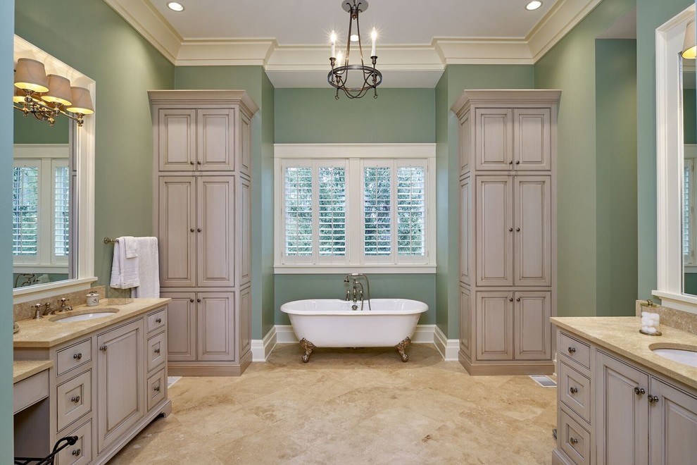 Photo of a large classic ensuite bathroom in Atlanta with a claw-foot bath, green walls, a submerged sink, raised-panel cabinets, grey cabinets, beige tiles, porcelain tiles, porcelain flooring and granite worktops.