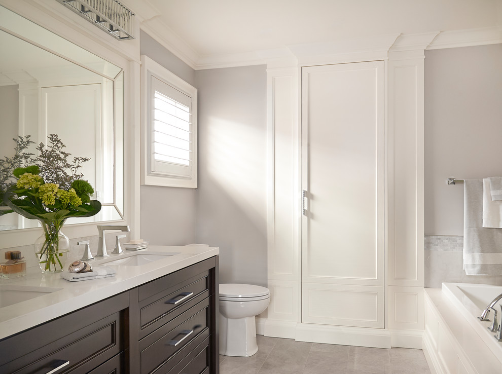 Bathroom - mid-sized transitional 3/4 gray tile and marble tile porcelain tile and gray floor bathroom idea in Toronto with a one-piece toilet, an undermount sink, quartz countertops, a hinged shower door, gray walls, shaker cabinets and gray cabinets