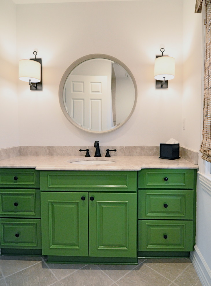 Inspiration for a mid-sized kids' beige tile and ceramic tile ceramic tile drop-in bathtub remodel in New York with an undermount sink, raised-panel cabinets, green cabinets, limestone countertops and white walls