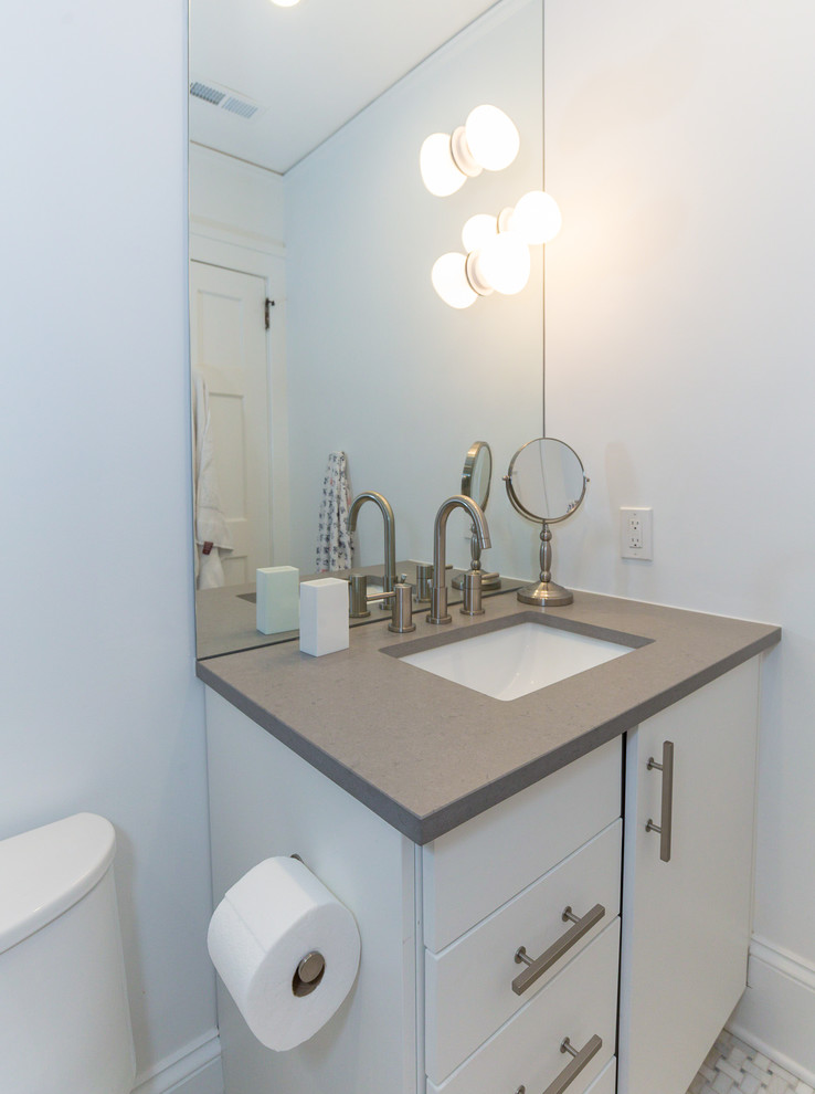 This is an example of a medium sized classic family bathroom in Charlotte with flat-panel cabinets, white cabinets, a freestanding bath, an alcove shower, a one-piece toilet, white tiles, mosaic tiles, white walls, marble flooring, a submerged sink and quartz worktops.