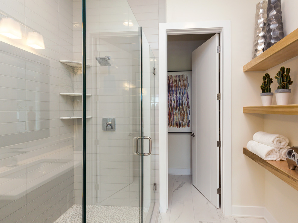 Inspiration for a large transitional master glass tile and gray tile porcelain tile and white floor corner shower remodel in Other with flat-panel cabinets, dark wood cabinets, a one-piece toilet, white walls, an undermount sink, quartz countertops and a hinged shower door